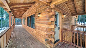 A wooden cabin with a covered porch, large windows, and a door with a small porch. - Woodsy Mountain Cabin: 2 Mi to Angel Fire Resort! (Angel Fire)