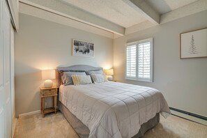 A bedroom with a bed, bedside lamps, a window, and artwork on the walls. - Walk to Main St! Condo w/ Hot Tub & Pool in Frisco (Frisco)