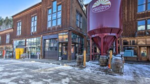 A wooden building with large windows and a prominent red water tower. - Telluride Studio in Downtown - Walk to Gondola! (Telluride)