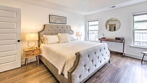 A bedroom with a large bed, a nightstand, a desk, a chair, and a ceiling fan. - Family-friendly Calera Getaway w/ Game Room! (Calera)