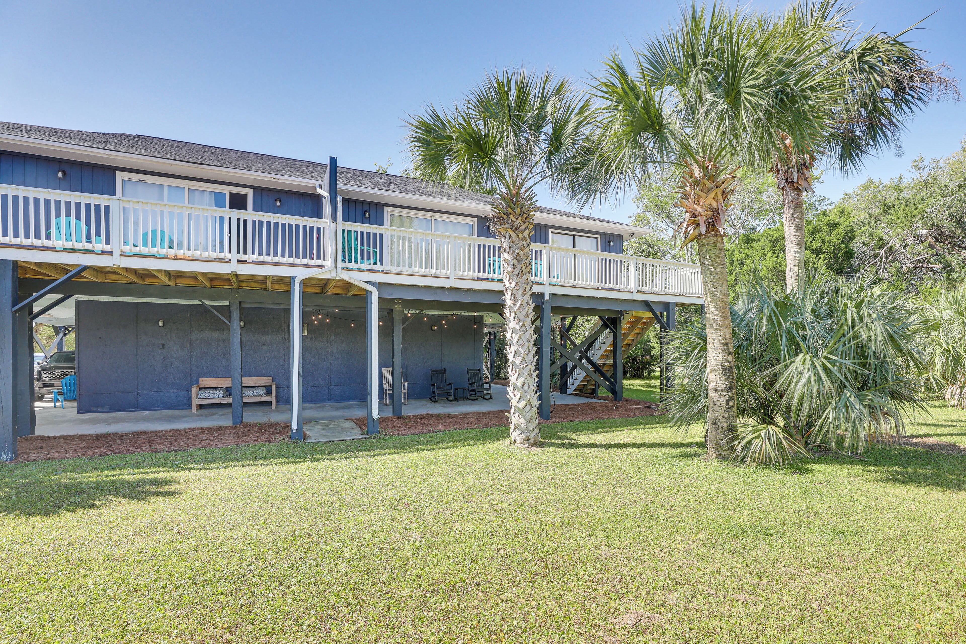 A two-story building with a balcony and outdoor seating area.