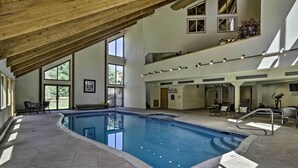 An indoor swimming pool with stone flooring, wooden beams, and multiple seating areas. - Deck + Mtn View: Keystone Townhome Near Resort! (Keystone)