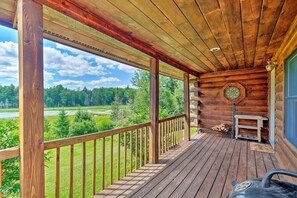 A wooden deck with a view of a green landscape. - Jacksonville Cabin w/ Wraparound Deck & Views (Jacksonville)