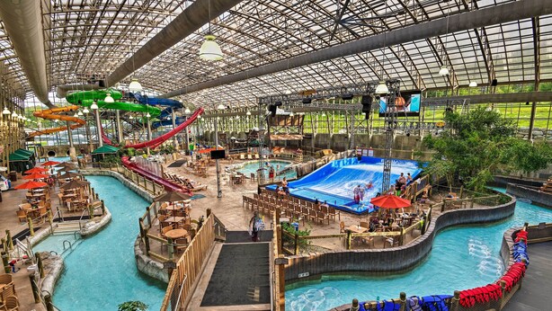 An indoor water park with multiple slides, pools, and seating areas. - Ski-in Resort Family Condo w/ Deck at Jay Peak! (North Troy)