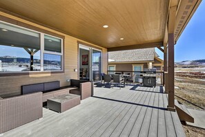 Relax on the covered patio with wicker sofas and chairs, a grill, and dining table.