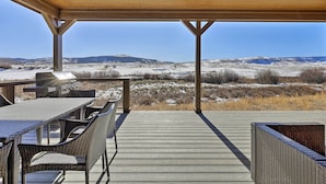 A covered outdoor patio with a view of snow-covered hills and a grill. - 3 Mi to Granby Ranch: Expansive Granby Retreat! (Granby)