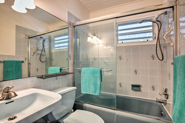 A bathroom with a glass-enclosed shower, a white sink, and a toilet. - St Croix Home w/ Caribbean Views - 1 Mi to Beach (Kingshill)