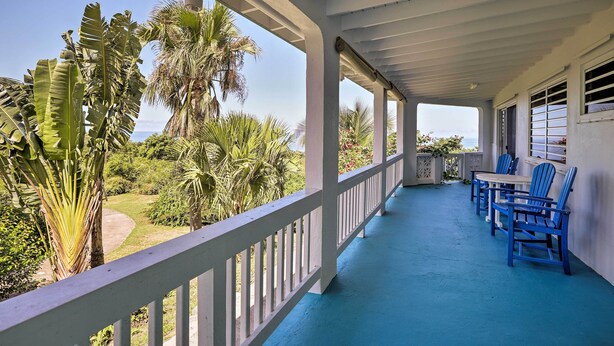 A covered porch with a blue floor, white railing, and blue chairs. - St Croix Home w/ Caribbean Views - 1 Mi to Beach (Kingshill)