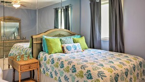 A bedroom with a bed, a mirror, a dresser, and a ceiling fan. - St Croix Home w/ Caribbean Views - 1 Mi to Beach (Kingshill)
