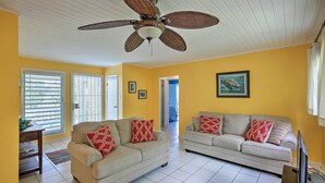 A living room with two sofas, a ceiling fan, and a television. - St Croix Home w/ Caribbean Views - 1 Mi to Beach (Kingshill)