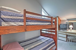 A bunk bed with striped bedding, a desk with a computer and lamp, and a chair. - Nice Galena Home w/ Huge Patio, Hot Tub & Fire Pit (Galena)