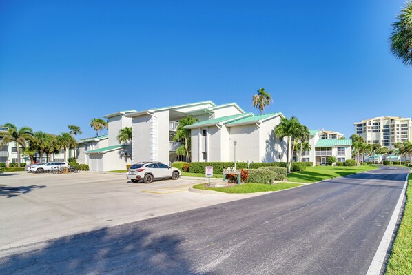 A hotel with a green roof, white exterior walls, and a parking lot. - Hutchinson Island Vacation Rental w/ Beach Access! (Fort Pierce)
