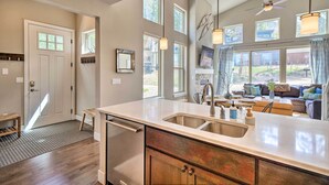 A modern kitchen with a large island, stainless steel appliances, and a view to the living area. - 'rendezvous Buckhorn Cabin' By Hiking Trails (Fraser)