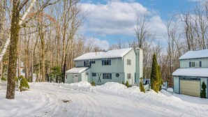 A two-story house with a snow-covered driveway and a garage. - Near Hiking & Skiing: Home in Wilmington! (Wilmington)