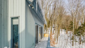 A wooden building with a covered porch and a snow-covered yard. - Near Hiking & Skiing: Home in Wilmington! (Wilmington)