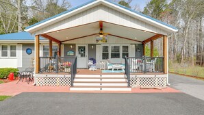 A two-story building with a covered porch, outdoor seating, and a visible staircase. - Families w/ Pets! Home 4 Mi to Ocean City Beach (Berlin)