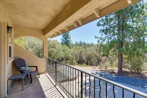 A covered balcony with a view of a road and trees. - Colfax Getaway w/ Hot Tub, Mountain Views! (Colfax)