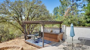 Eine Terrasse im Freien mit einer Pergola, einer Sitzecke und einem kleinen Pool.