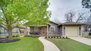 A residential house with a front porch, a garage, and a driveway. - Cocktail Pool! Fredericksburg Bungalow By Main St (Fredericksburg)