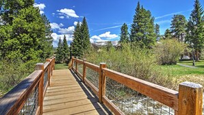 A wooden bridge with railings leading to a mountainous landscape. - Ski-in Breck Condo: Walk to Shops & Restaurants! (Breckenridge)