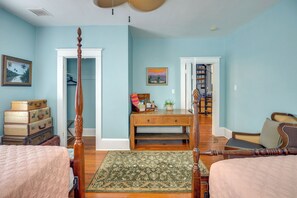 A bedroom with a four-poster bed, a desk with a chair, a wardrobe, and a bookshelf. - Downtown Daytona Beach Unit: Walk to Halifax River (Daytona Beach)
