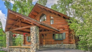 A log cabin with a stone foundation, a porch, and a stone wall. - Ski-in/ski-out Telluride Home w/ Deck & Hot Tub! (Telluride)