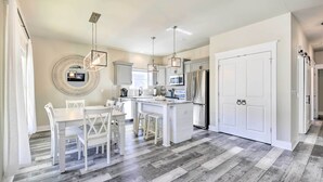 A modern kitchen with white cabinetry, a central island, and stainless steel appliances. - Modern Santa Rosa Beach Retreat w/ Yard & Patio! (Santa Rosa Beach)