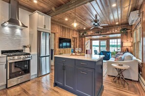 A modern kitchen with wooden cabinetry, stainless steel appliances, and a central island. - Charming Bristol Cottage w/ Private Beach! (Bristol)