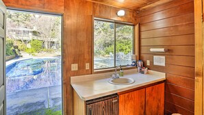 A wooden interior with a sink and window. - Woodsy Willow Creek Getaway w/ Pool & Deck! (Willow Creek)