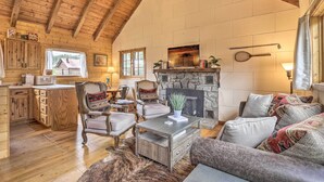 A rustic cabin interior with a kitchen, dining area, and living room. - Walk to Grand Lake: Historic Dtwn Cabin! (Grand Lake)