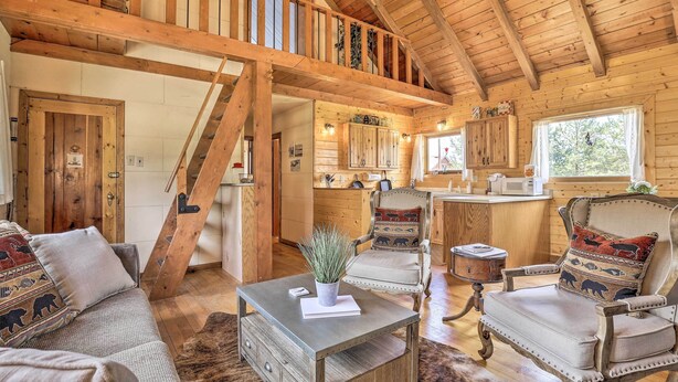 A rustic cabin interior with a loft bedroom, wooden furniture, and a cozy fireplace. - Walk to Grand Lake: Historic Dtwn Cabin! (Grand Lake)