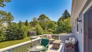 A deck with outdoor furniture, a table, and a wicker sofa. - Bright Narragansett Beach Escape w/ Deck & Yard! (Narragansett)