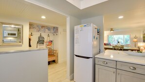 A kitchen with a refrigerator, microwave, and wooden cabinets. - Siesta Key Condo w/ Heated Pool < 1 Mi to Beach (Siesta Key)