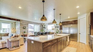 A spacious kitchen with a central island, stainless steel appliances, and pendant lighting. - Stunning Home w/ Hot Tub Near Park City Skiing! (Park City)