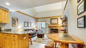 A spacious kitchen with wooden cabinets, a granite countertop, and a large island with stools. - Ski & Relax Fireside: Frisco Gem w/ Resort Perks! (Frisco)