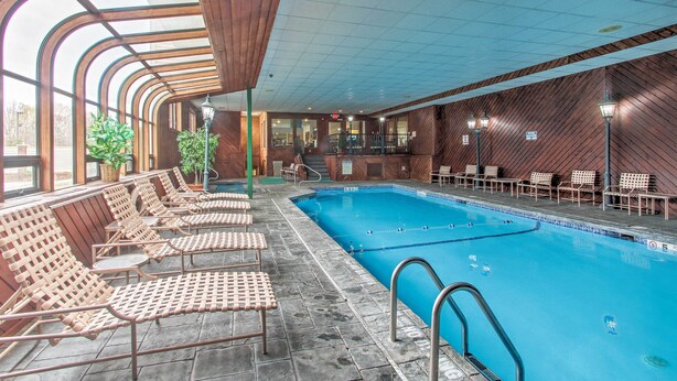 An indoor swimming pool with lounge chairs and a wooden wall. - Lincoln Resort Condo w/ Pool Access - Near Hiking! (Lincoln)
