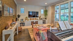 A living room with a piano, a television, and a large window. - Pool & Hot Tub: Ideally Located 'austin Oasis' (Austin)
