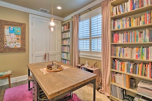 A room with a wooden table, a bookshelf, and a window with blinds. - Pool & Hot Tub: Ideally Located 'austin Oasis' (Austin)