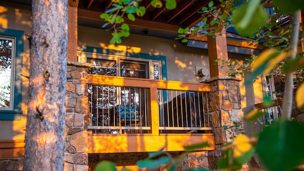 A stone building with a balcony, wooden beams, and a window with a metal railing. - The Chelsea Condo w/ Hot Tub & Pool Access! (Breckenridge)