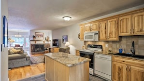 A modern kitchen with wooden cabinets, a granite countertop, and a built-in oven.