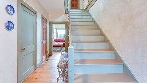 A staircase with a wooden handrail and a light blue wall. - Manchester Center Home w/ Green Mtn Views! (Manchester Center)
