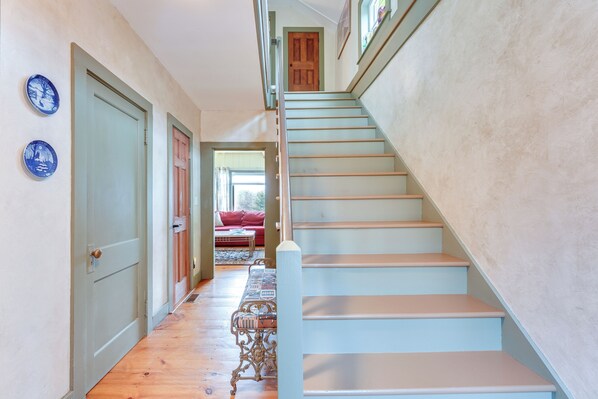 A staircase with a wooden handrail and a light blue wall. - Manchester Center Home w/ Green Mtn Views! (Manchester Center)