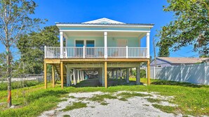A two-story house with a balcony, a covered porch, and a gravel driveway. - Near Downtown + Ocean: Sarasota Getaway (Sarasota)
