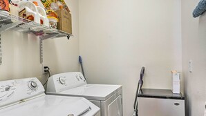 A laundry area with two front-loading washers, a dryer, and a vacuum cleaner. - 2 Mi to Coachella: Indio Home w/ Fire Pit! (Indio)