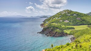 A coastal landscape with a golf course and houses on a hillside. - St Thomas Cliffside Villa With Pool & Hot Tub! (St. Thomas)