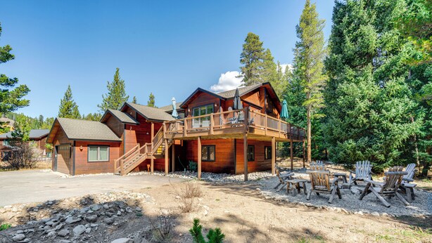 A wooden cabin with a deck, outdoor seating, and a clear view of the surrounding forest. - 5 Mi to Ski Resort: Breck Home w/ Hot Tub! (Breckenridge)