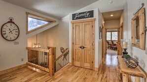 A wooden staircase with a "Family" sign, a clock, and a view through a window. - 5 Mi to Ski Resort: Breck Home w/ Hot Tub! (Breckenridge)