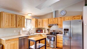 A modern kitchen with wooden cabinets, stainless steel appliances, a built-in oven, and a microwave. - Pet-friendly Bend Home ~ 2 Mi to Downtown (Bend)