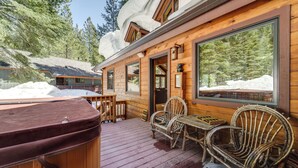 A wooden cabin with a deck, large windows, and a hot tub. - 'one Moose Lodge' Tahoe Donner Vacation Rental! (Truckee)