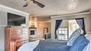 A bedroom with a bed, dresser, and a television. - Canyon Lake Home: Hill Country & Water Views! (Canyon Lake)
